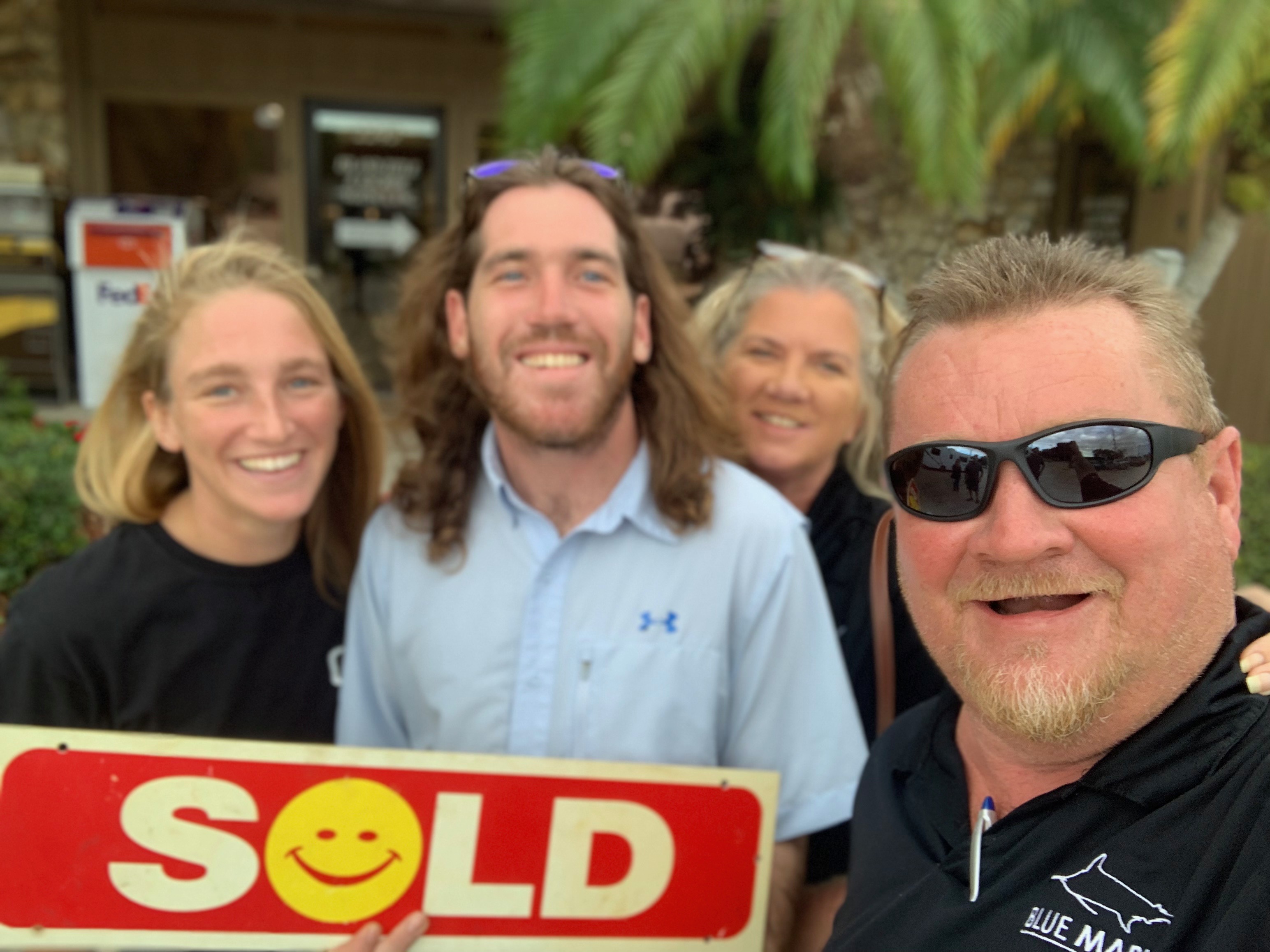 Happy clients celebrating a sold real estate transaction